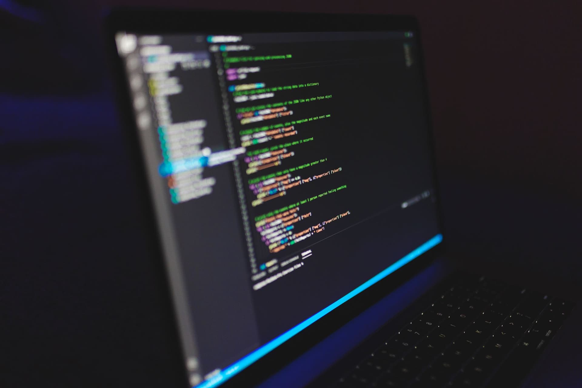 Un editor de código abierto en la pantalla de un portátil en una sala oscura